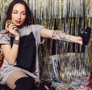 Happy Indian user holding a smartphone with the LemonBook app open, showing a sleek user interface and a live chat bubble indicating quick customer support response.