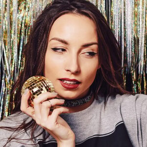 Happy Indian user holding a smartphone with the LemonBook app open, showing a sleek user interface and a live chat bubble indicating quick customer support response.